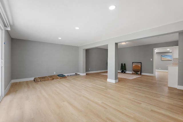 3926 Helena St NE, Saint Petersburg, FL 33703 - unfurnished living room with light wood-type flooring, baseboards, and recessed lighting