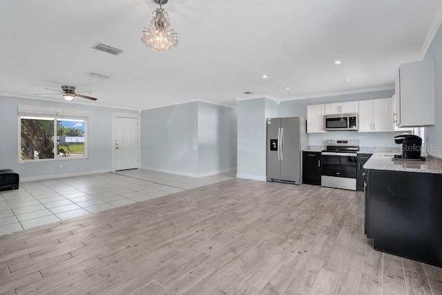950 Gatewood Ct NE, Palm Bay, FL 32905 - kitchen with stainless steel appliances, open floor plan, ornamental molding, light wood-type flooring, and baseboards