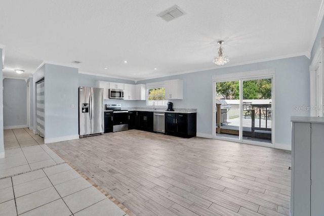 950 Gatewood Ct NE, Palm Bay, FL 32905 - kitchen featuring appliances with stainless steel finishes, crown molding, baseboards, light countertops, and white cabinetry