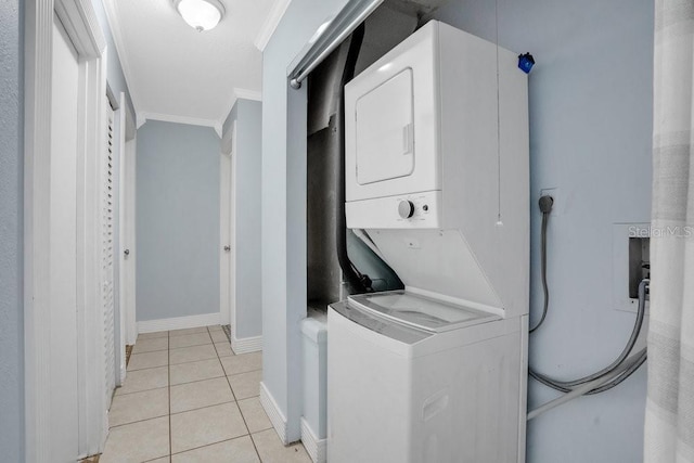 950 Gatewood Ct NE, Palm Bay, FL 32905 - washroom featuring stacked washer and clothes dryer, crown molding, light tile patterned floors, and baseboards