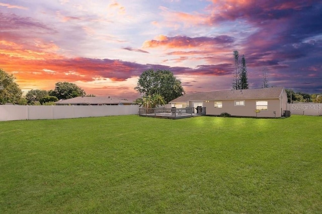 950 Gatewood Ct NE, Palm Bay, FL 32905 - yard at dusk with a deck and central AC