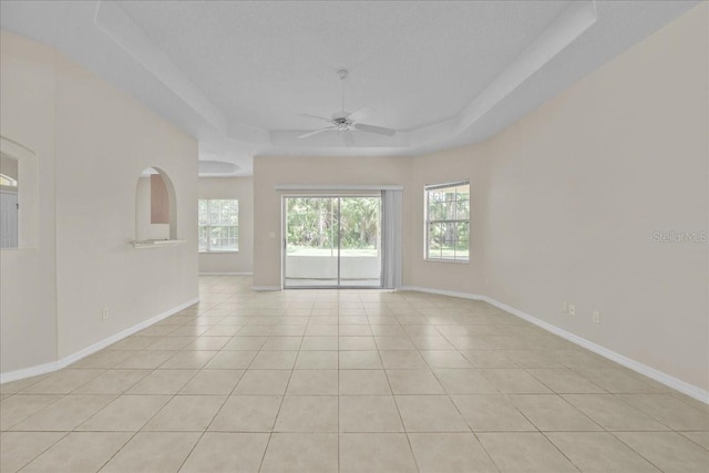 45 Powder Horn Dr, Palm Coast, FL 32164 - spare room featuring ceiling fan, a raised ceiling, baseboards, and light tile patterned floors