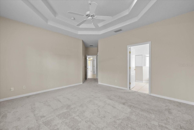 45 Powder Horn Dr, Palm Coast, FL 32164 - unfurnished bedroom featuring a tray ceiling, carpet flooring, connected bathroom, and baseboards