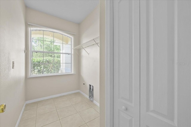 45 Powder Horn Dr, Palm Coast, FL 32164 - laundry area featuring hookup for an electric dryer, light tile patterned floors, and baseboards