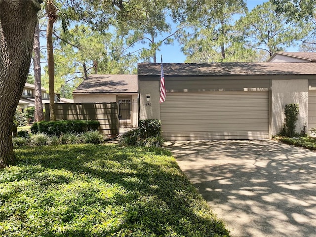 650 Woodridge Dr, Fern Park, FL 32730 - view of front of house with stucco siding, a garage, driveway, and roof with shingles