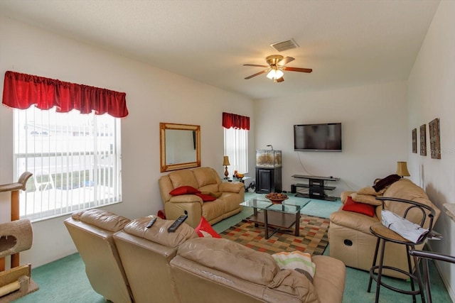 living area featuring carpet flooring and a ceiling fan