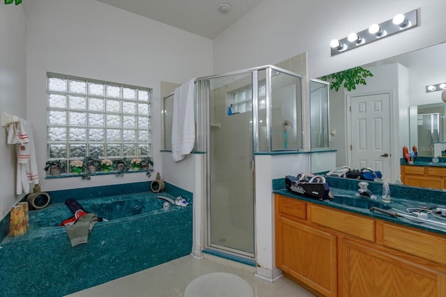 full bath featuring a stall shower, vanity, a garden tub, and tile patterned flooring