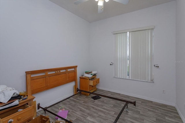 bedroom with wood finished floors, baseboards, and ceiling fan