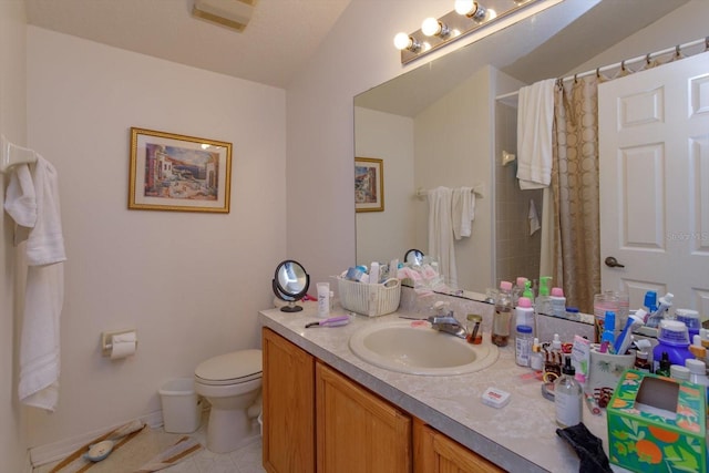 bathroom featuring toilet, tile patterned flooring, vanity, and a shower with shower curtain