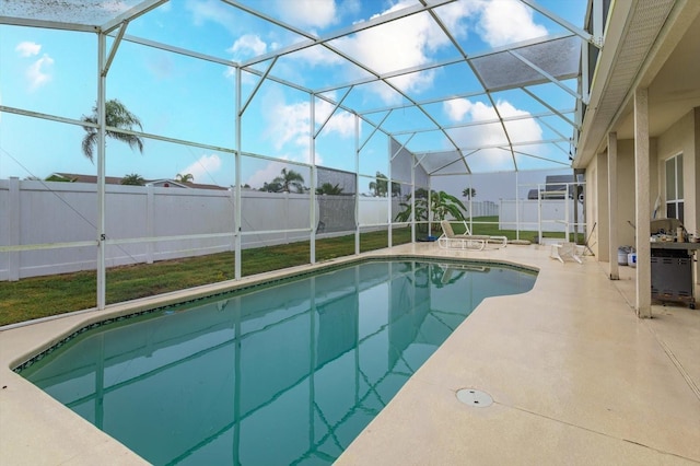 view of swimming pool with a patio, a fenced backyard, and a lanai