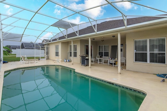 outdoor pool with a patio area, a grill, and a lanai