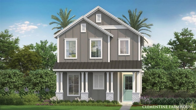 2054 Education St, Saint Cloud, FL 34771 - view of front of home with board and batten siding, metal roof, brick siding, covered porch, and a standing seam roof