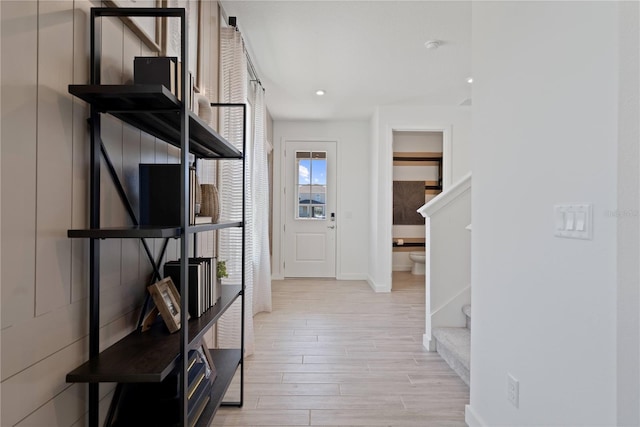 2054 Education St, Saint Cloud, FL 34771 - hallway with light wood-style floors, stairway, and baseboards