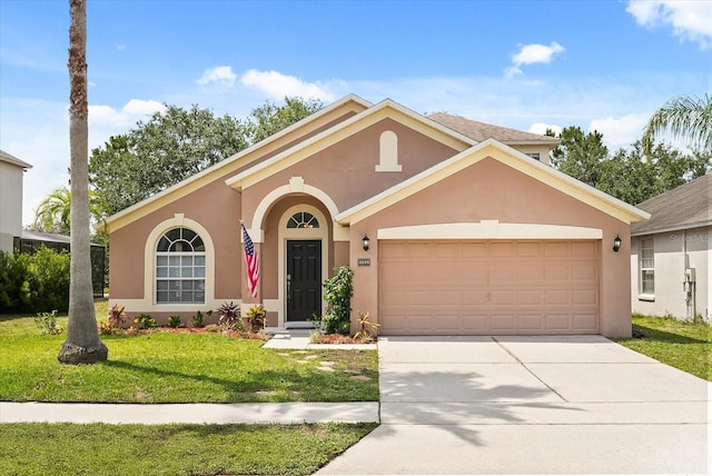 4249 Andover Cay Blvd, Orlando, FL 32825 - view of front of home featuring a garage, stucco siding, a front yard, and concrete driveway