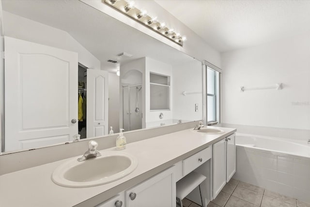 4249 Andover Cay Blvd, Orlando, FL 32825 - full bath featuring double vanity, a garden tub, tile patterned flooring, a stall shower, and a spacious closet