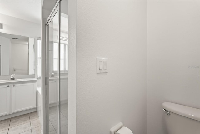 4249 Andover Cay Blvd, Orlando, FL 32825 - bathroom with toilet, vanity, tile patterned flooring, a textured wall, and a stall shower
