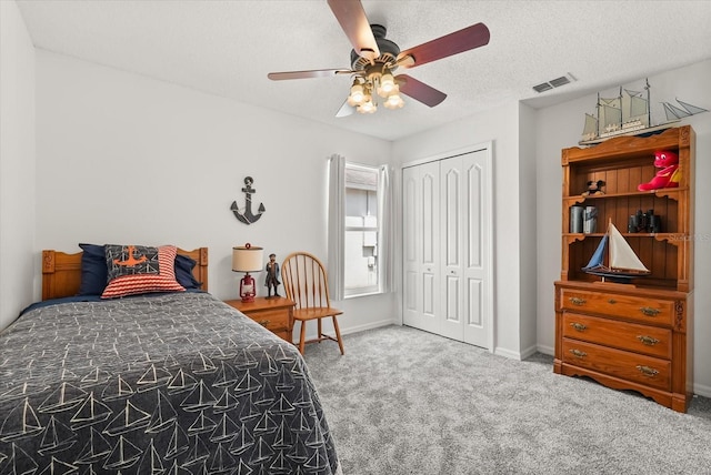 4249 Andover Cay Blvd, Orlando, FL 32825 - carpeted bedroom with a closet, baseboards, a ceiling fan, and a textured ceiling