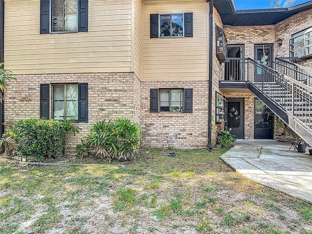1748 Foxhall Cir Unit 1748, Kissimmee, FL 34741 - view of front facade featuring brick siding and stairs
