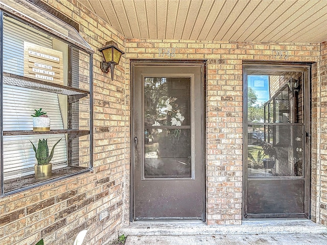 1748 Foxhall Cir Unit 1748, Kissimmee, FL 34741 - doorway to property with brick siding and a porch