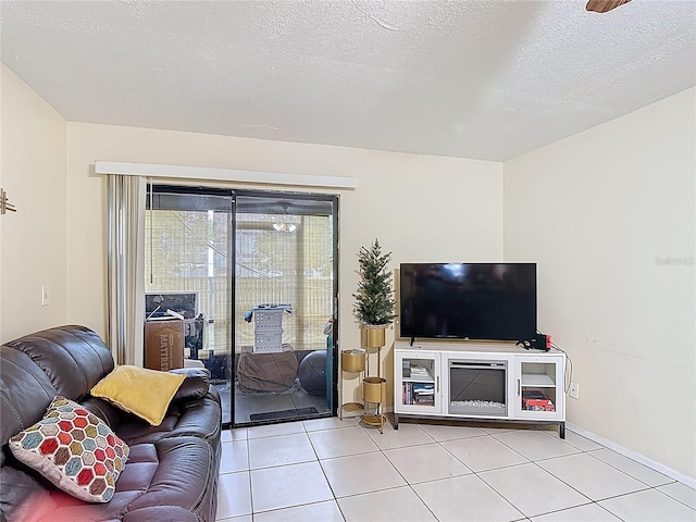 1748 Foxhall Cir Unit 1748, Kissimmee, FL 34741 - living area with light tile patterned floors, a textured ceiling, and baseboards
