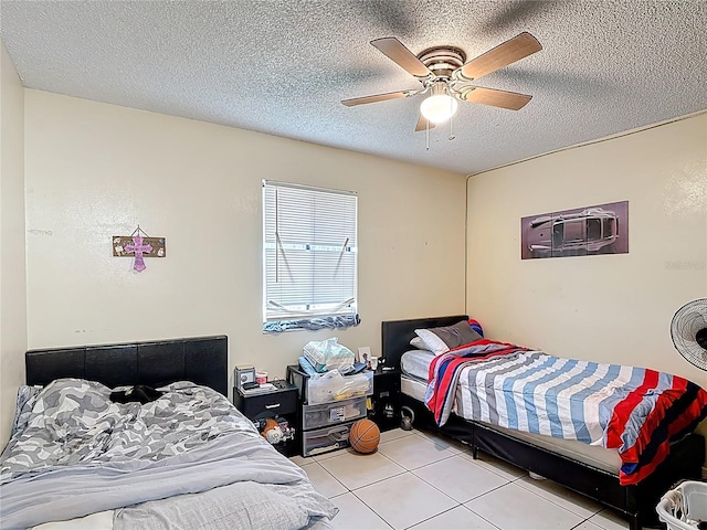 1748 Foxhall Cir Unit 1748, Kissimmee, FL 34741 - bedroom featuring tile patterned flooring, a ceiling fan, and a textured ceiling