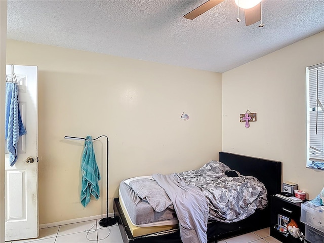 1748 Foxhall Cir Unit 1748, Kissimmee, FL 34741 - bedroom with light tile patterned floors, ceiling fan, and a textured ceiling
