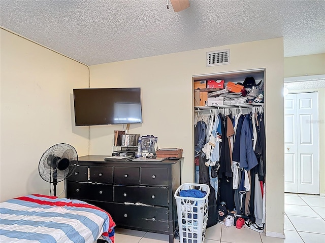 1748 Foxhall Cir Unit 1748, Kissimmee, FL 34741 - tiled bedroom featuring a closet and a textured ceiling