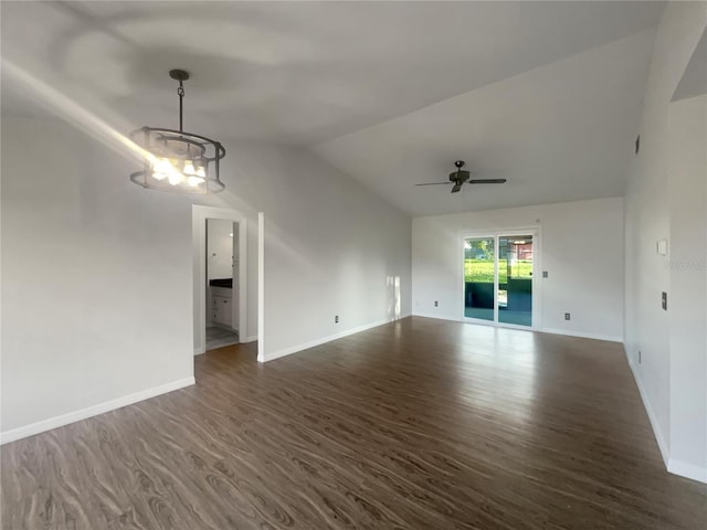 3321 Crimson Ln, Deltona, FL 32738 - unfurnished living room featuring dark wood-style flooring, baseboards, a chandelier, lofted ceiling, and ceiling fan
