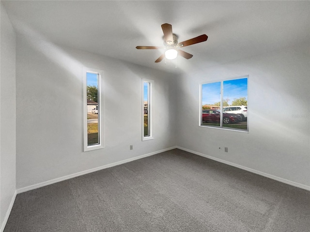 3321 Crimson Ln, Deltona, FL 32738 - spare room with dark colored carpet, a ceiling fan, and baseboards