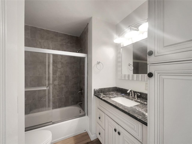 3321 Crimson Ln, Deltona, FL 32738 - full bathroom with vanity, combined bath / shower with glass door, toilet, and wood finished floors