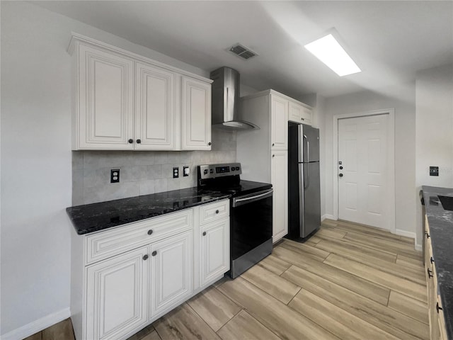 3321 Crimson Ln, Deltona, FL 32738 - kitchen featuring stainless steel appliances, wall chimney range hood, backsplash, white cabinetry, and wood finish floors