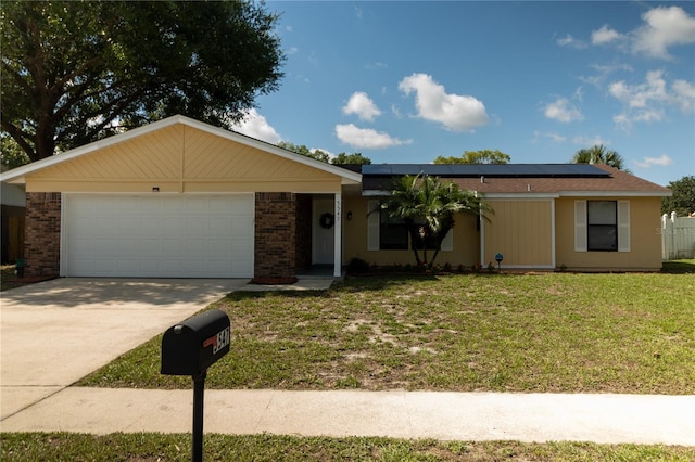 5547 Garden Grove Cir, Winter Park, FL 32792 - ranch-style house featuring a front yard, driveway, an attached garage, roof mounted solar panels, and brick siding