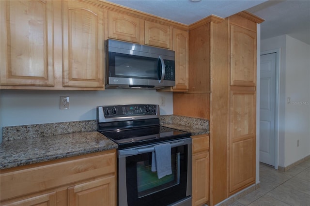 5547 Garden Grove Cir, Winter Park, FL 32792 - kitchen with stainless steel appliances, light tile patterned floors, light stone counters, and light brown cabinets