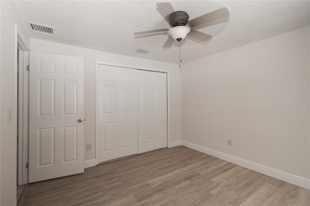 5547 Garden Grove Cir, Winter Park, FL 32792 - unfurnished bedroom featuring light wood finished floors, baseboards, a closet, and a ceiling fan