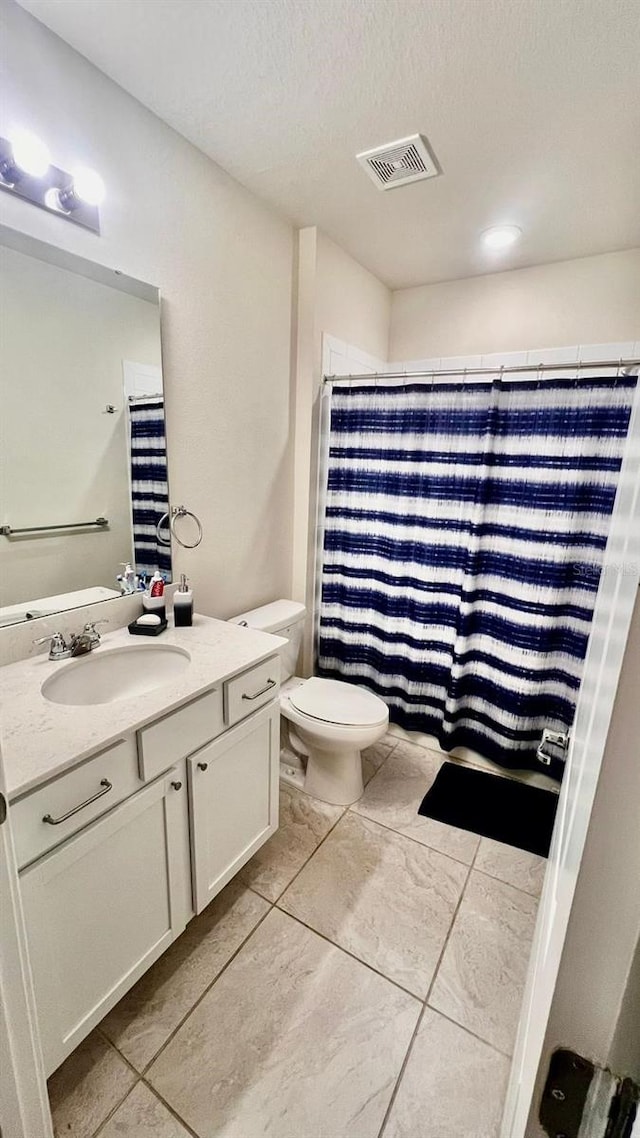 17148 Cagan Crossings Blvd, Clermont, FL 34714 - full bathroom with tile patterned flooring, vanity, toilet, a textured ceiling, and a shower with curtain