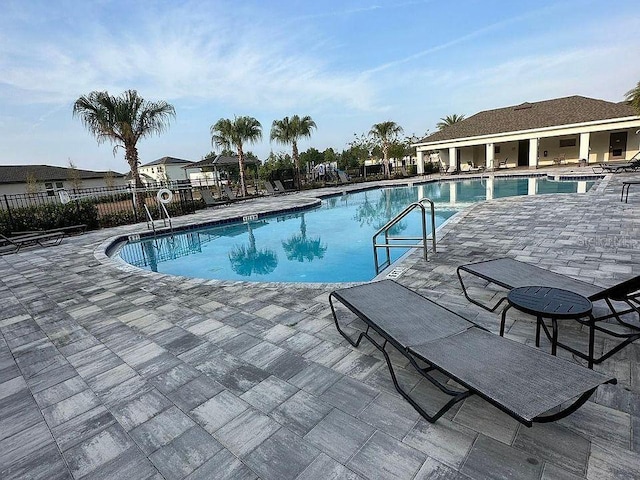 17148 Cagan Crossings Blvd, Clermont, FL 34714 - community pool with fence and a patio