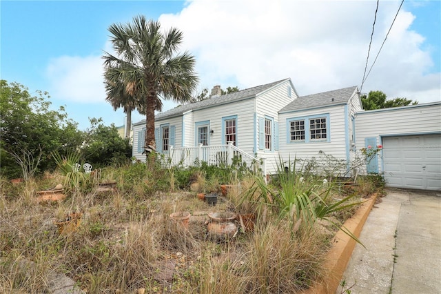330 Phoenix Ave, Daytona Beach, FL 32118 - view of front of property with driveway, a garage, and a shingled roof