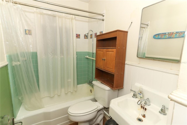330 Phoenix Ave, Daytona Beach, FL 32118 - bathroom with shower / bathtub combination with curtain, toilet, a sink, and wainscoting