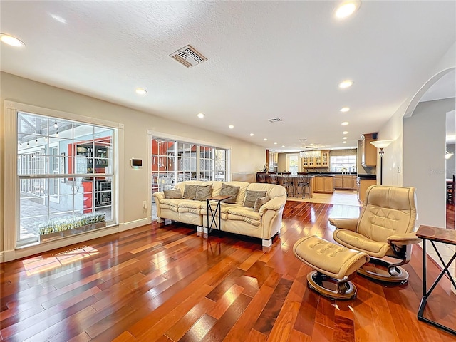 5127 Leeward Way, Orlando, FL 32809 - living area featuring wood finished floors, arched walkways, recessed lighting, and baseboards