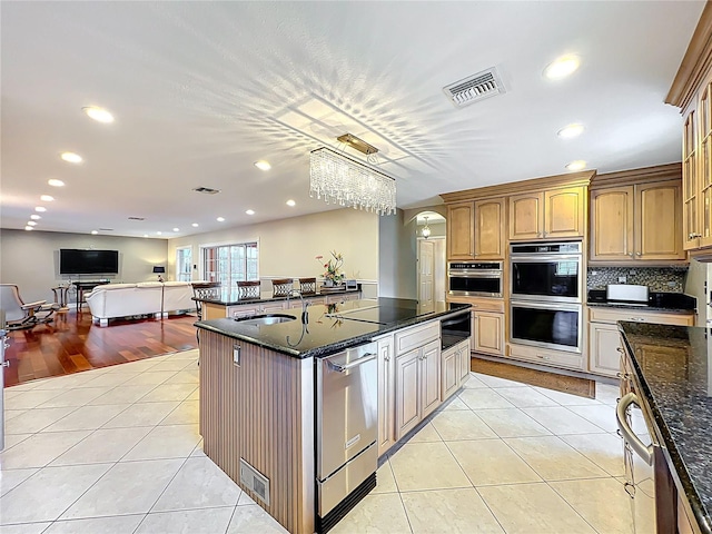 5127 Leeward Way, Orlando, FL 32809 - kitchen with stainless steel appliances, light tile patterned floors, a sink, a warming drawer, and recessed lighting