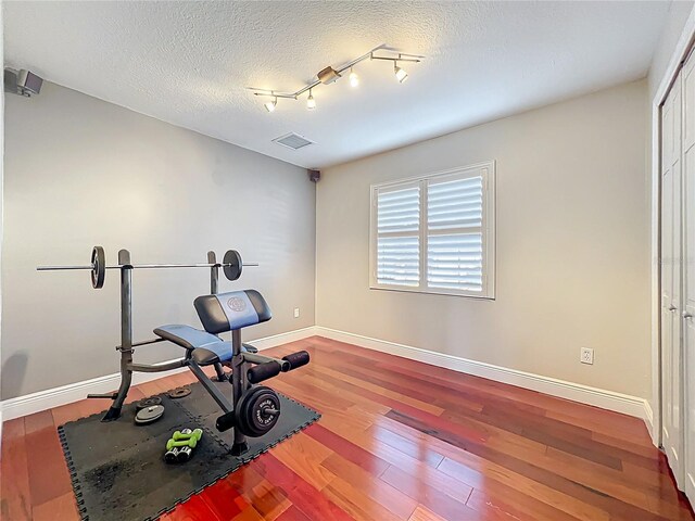 5127 Leeward Way, Orlando, FL 32809 - workout area with baseboards, wood finished floors, and a textured ceiling