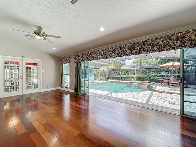 5127 Leeward Way, Orlando, FL 32809 - unfurnished room with a ceiling fan, wood finished floors, a textured ceiling, lofted ceiling, and baseboards