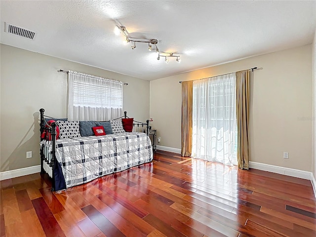 5127 Leeward Way, Orlando, FL 32809 - bedroom with wood finished floors, baseboards, and rail lighting