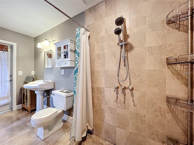 5127 Leeward Way, Orlando, FL 32809 - bathroom featuring toilet, a tile shower, baseboards, and tile patterned floors