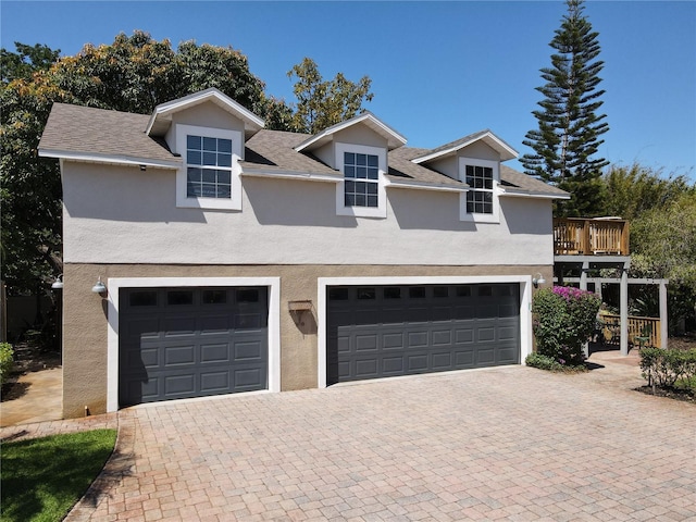 5127 Leeward Way, Orlando, FL 32809 - traditional home featuring stucco siding, decorative driveway, and a garage