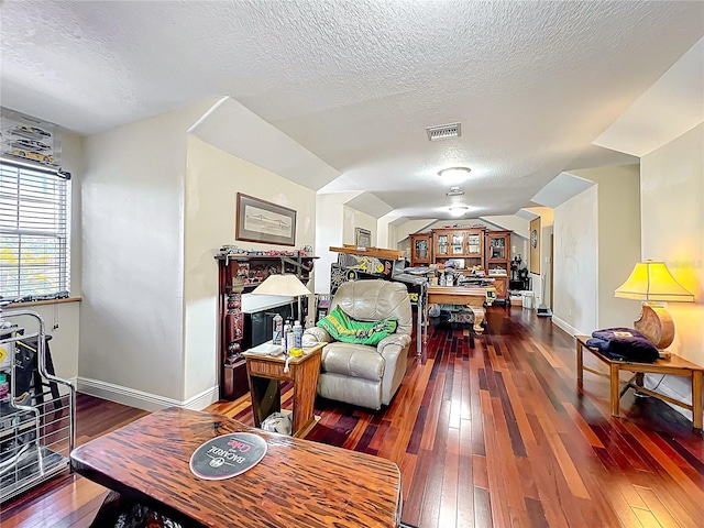 5127 Leeward Way, Orlando, FL 32809 - living room featuring hardwood / wood-style flooring, a textured ceiling, baseboards, and lofted ceiling