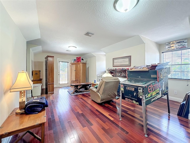 5127 Leeward Way, Orlando, FL 32809 - living room with a textured ceiling, wood-type flooring, and baseboards