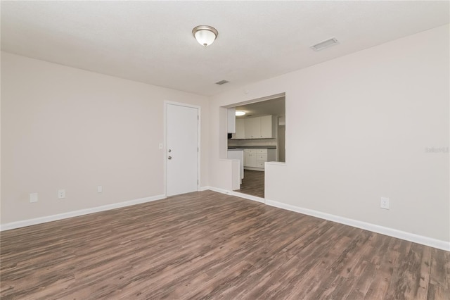 6426 Eden Ln, Tampa, FL 33634 - unfurnished room featuring dark wood-style floors and baseboards
