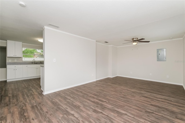 6426 Eden Ln, Tampa, FL 33634 - spare room with dark wood-type flooring, crown molding, a ceiling fan, electric panel, and baseboards