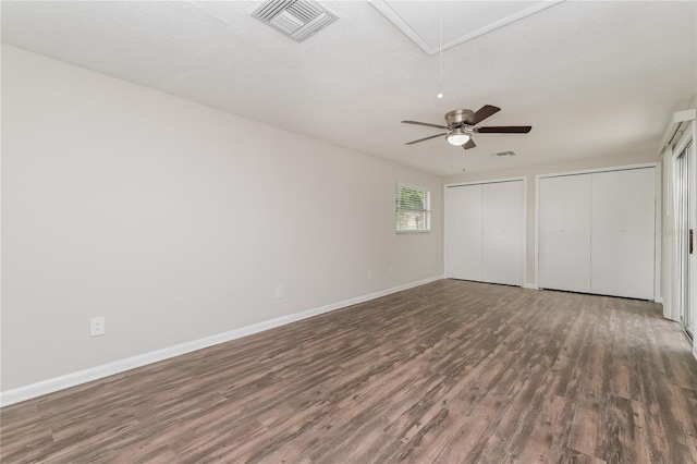 6426 Eden Ln, Tampa, FL 33634 - unfurnished bedroom with wood finished floors, attic access, multiple closets, and baseboards